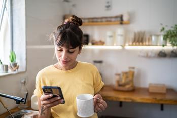 Can Apple Stock Double in 5 Years? Here's What It Would Take.: https://g.foolcdn.com/editorial/images/752151/using-iphone-drinking-coffee-in-kitchen.jpg