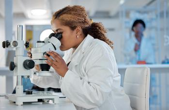 2 Top Biotech Stocks That Wall Street Thinks Could Soon Double in Value: https://g.foolcdn.com/editorial/images/766030/scientist-looks-into-microscope-while-sitting-at-bench-in-laboratory.jpg