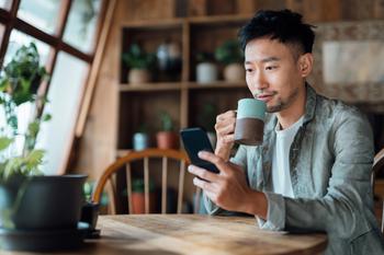 PayPal Is Winning Behind the Scenes. And This Huge Expanded Partnership With Uber Proves It.: https://g.foolcdn.com/editorial/images/747406/person-sitting-drinking-coffee-with-a-mobile-phone.jpg