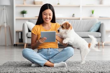 Is DocuSign Stock a Buy Now?: https://g.foolcdn.com/editorial/images/717033/using-a-tablet-with-her-dog.jpg