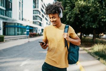 3 Top Dividend Stocks I Can't Wait to Buy In June: https://g.foolcdn.com/editorial/images/735422/walking-headphones-using-mobile-phone.jpg