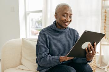 Want the Max $4,873 Social Security Benefit? Here's the Salary You Need.: https://g.foolcdn.com/editorial/images/763804/older-person-sitting-on-a-couch-looking-at-a-tablet.jpg