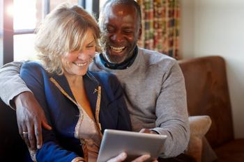 Could Pfizer Stock Help You Retire A Millionaire?: https://g.foolcdn.com/editorial/images/762144/gettyimages-two-people-smile-as-they-look-at-a-tablet.jpg