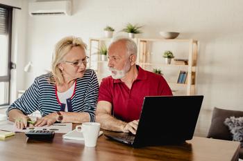 Will My Retirement Plan Withdrawals Impact My Social Security Benefits?: https://g.foolcdn.com/editorial/images/763065/senior-couple-laptop-gettyimages-1194939334.jpg