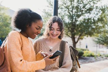 Better Tech Stock: Alphabet vs. Apple: https://g.foolcdn.com/editorial/images/755798/teen-shows-friend-something-on-their-smart-phone.jpg