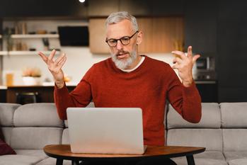 Over 50 and Laid Off? 3 Ways to Avoid a Forced Early Retirement.: https://g.foolcdn.com/editorial/images/774532/older-man-at-laptop-raising-his-arms-as-if-frustrated-gettyimages-1359039717.jpg