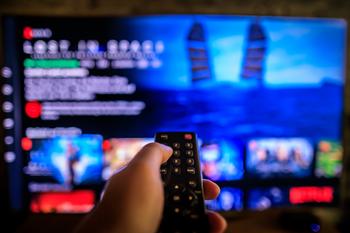 You Don't Have to Pick a Winner in Streaming. Here's Why: https://g.foolcdn.com/editorial/images/738874/left-hand-holding-remote-watching-streaming-tv.jpg