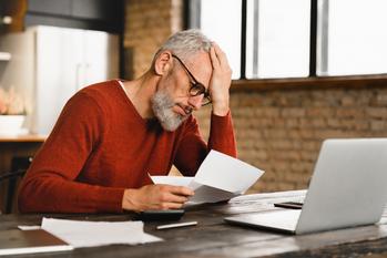 3 Reasons You May End Up Sorely Disappointed With Your Social Security Checks: https://g.foolcdn.com/editorial/images/771189/older-man-stressed-holding-document-at-laptop_gettyimages-1359033046.jpg